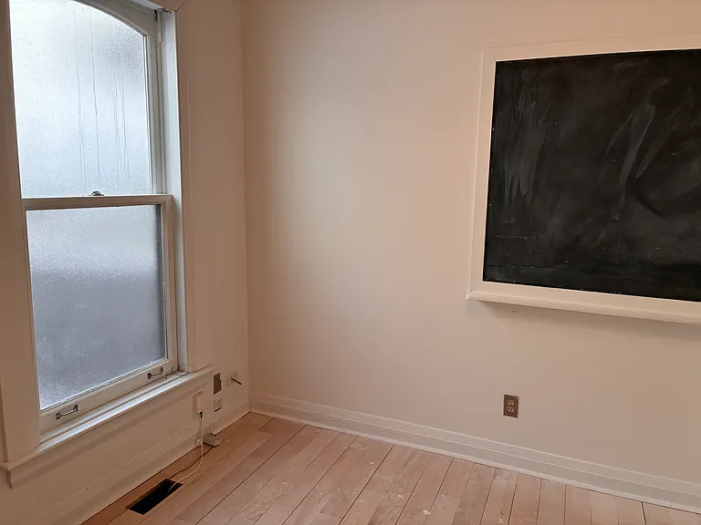 Bedroom located on the main floor. The windowpane is now clear glass.