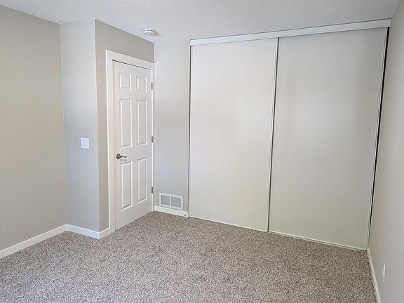 2nd bedroom closet with full height sliding doors.