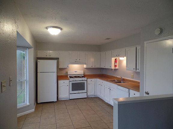 Kitchen (10' x 12'). Includes range, dishwasher, and refrigerator. To the left are bay windows.