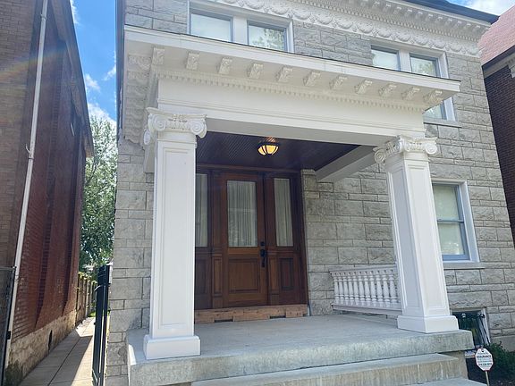 Rebuilt front porch with custom-built mahogany front door with side lites