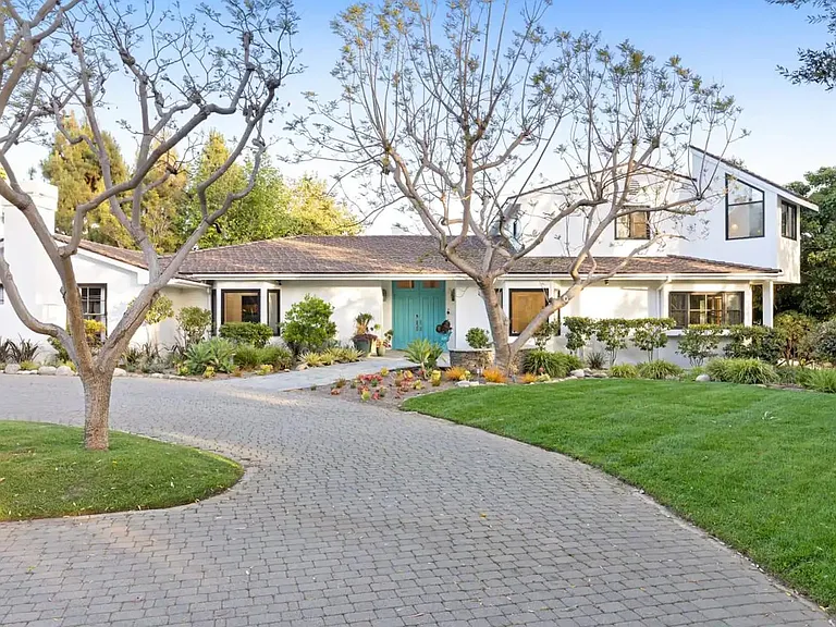 Let the beautiful garden and sprawling lawn welcome you home as you reach the front entrance!