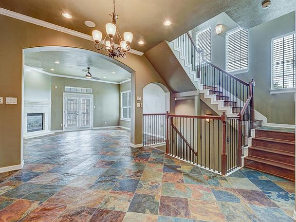 SECOND FLOOR; View of the dining room, den and staircase from the kitchen.