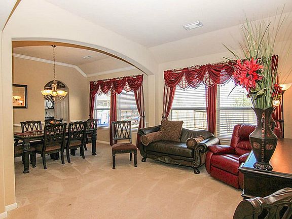 The formal living room is located to the right of the front door and offers large windows and arched entries.  This fabulous open floorplan makes entertaining a large group easy!