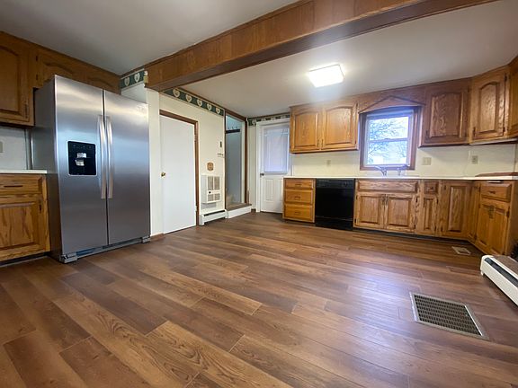 Access the primary bedroom with the back staircase off the kitchen