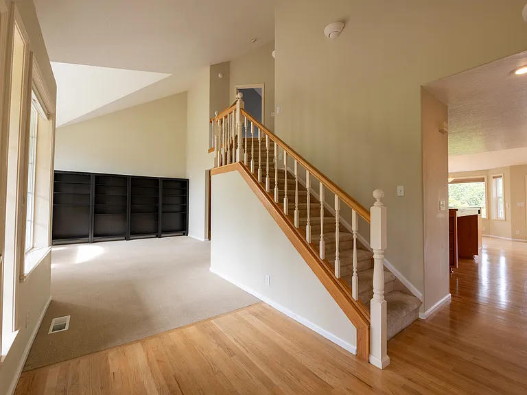 Living Room/Stairs/Kitchen (to right)/Front Door (to left)