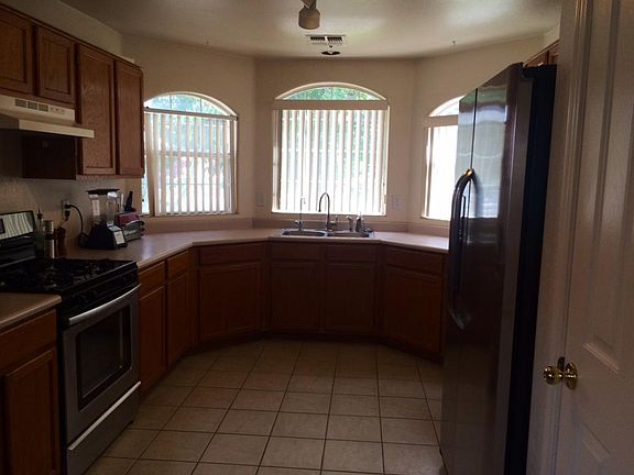 Kitchen with new stainless fridge & gas stove
