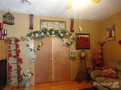 Living room with doors to the bedroom.
