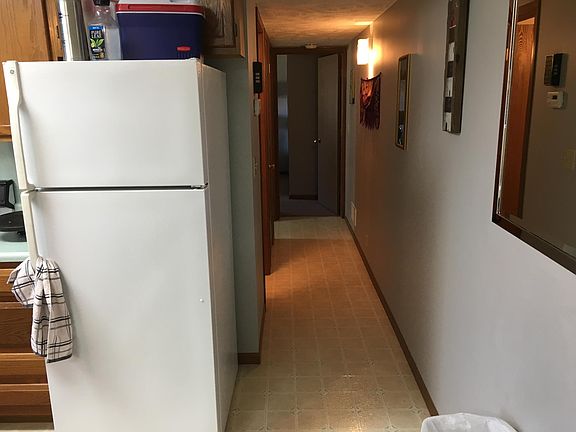 View down hallway from kitchen towards master bedroom.