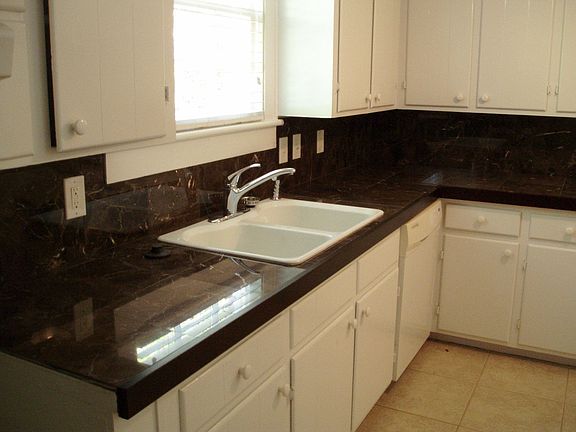 Newly updated with granite tiled counters and new white sink and faucets