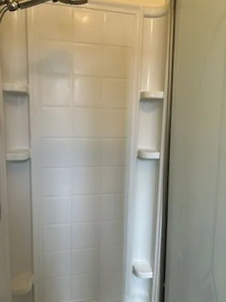 Master bath shower stall with hand-held nozzle