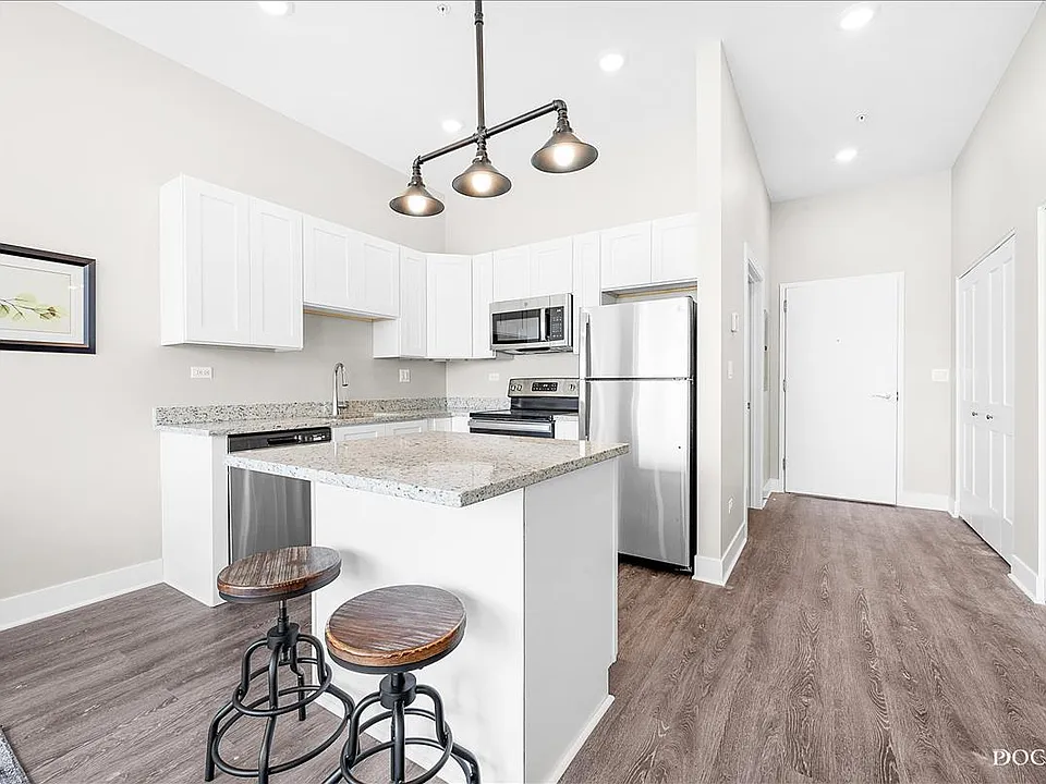 Kitchen with stainless steel appliances, soft close cabinets, and granite counters.