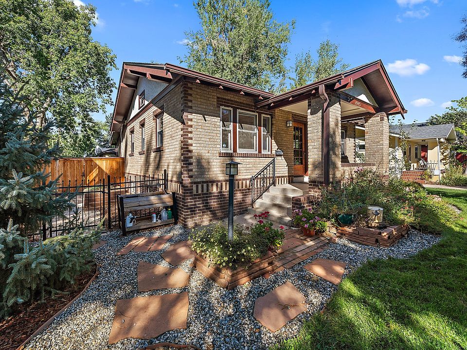 Front of house with porch, fresh gravel/flagstone walk, flowers and great landscaping