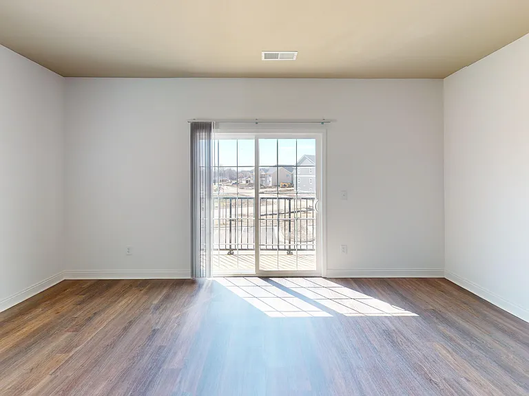 The Roth living room features wood-style floors and a sliding glass door that goes to the private patio/balcony. The Roth living room features wood-style floors and a sliding glass door that goes to the private patio/balcony.