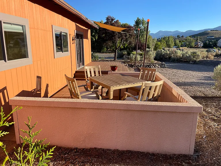 Looking south towards Jobs Peak with patio, deck and front door in background.