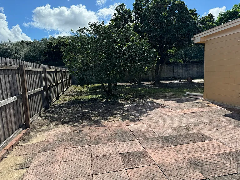 Brick lined patio within the backyard