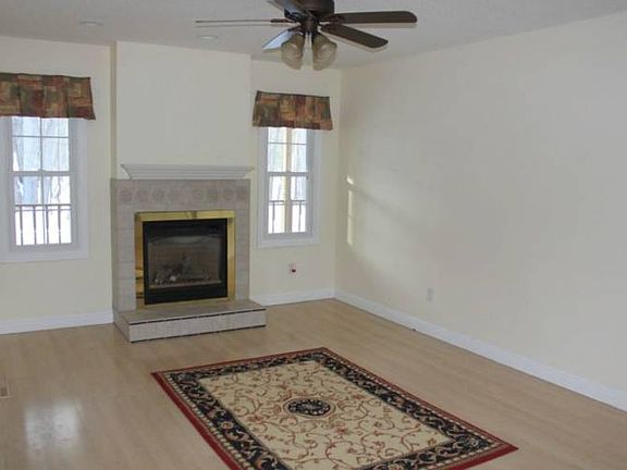Relax! The wood-look laminate flooring, ceiling fan and fireplace make this an ideal space for family time and entertaining.