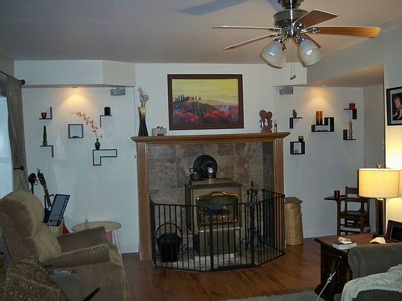 Coal stove w/ mantle, picture moves inside wall to reveal flat screen tv!