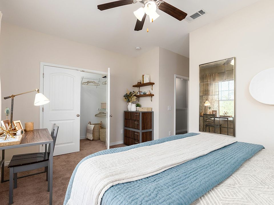 Relax in a Cozy Carpeted Bedroom with Ceiling Fan and Walk-In Closet at Seaglass Apartments