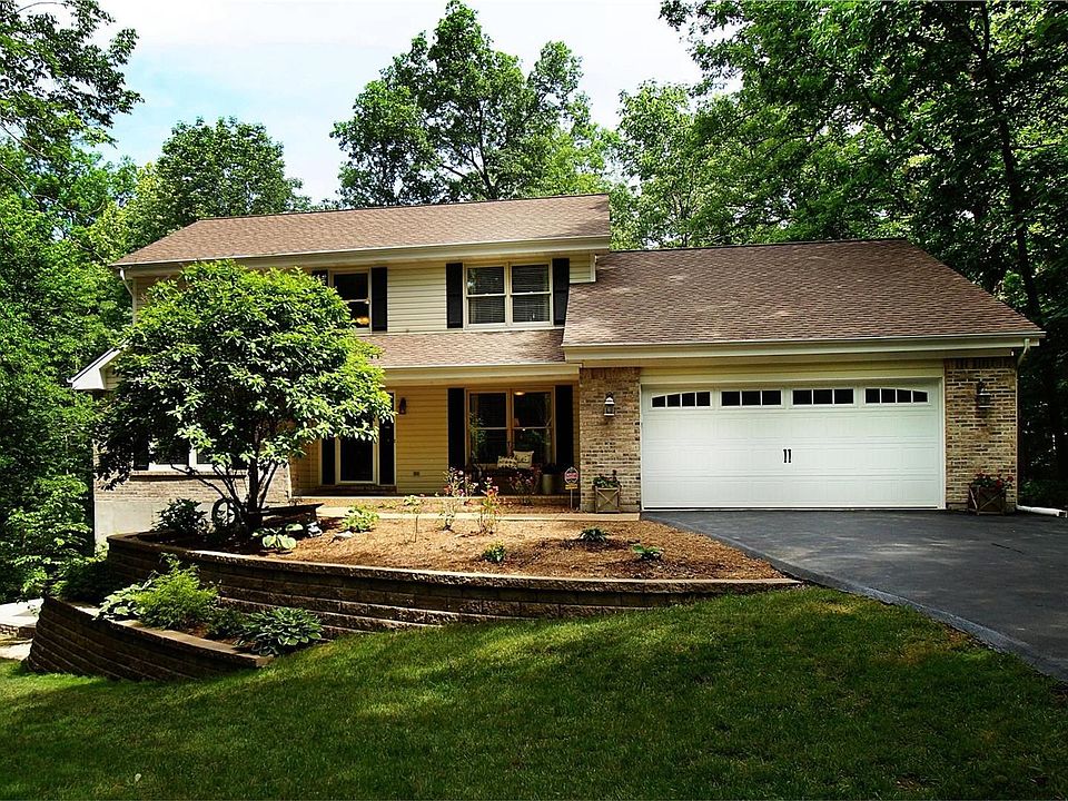 Front Of Home With New Double Tiered Stone Retaining Walls And Landscaping