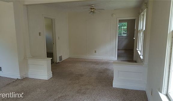 View of dining room from living room. Carpet will be removed