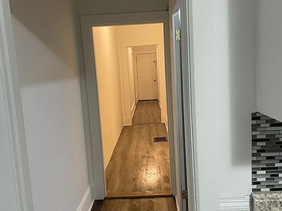 Long hall leading to kitchen from entrance