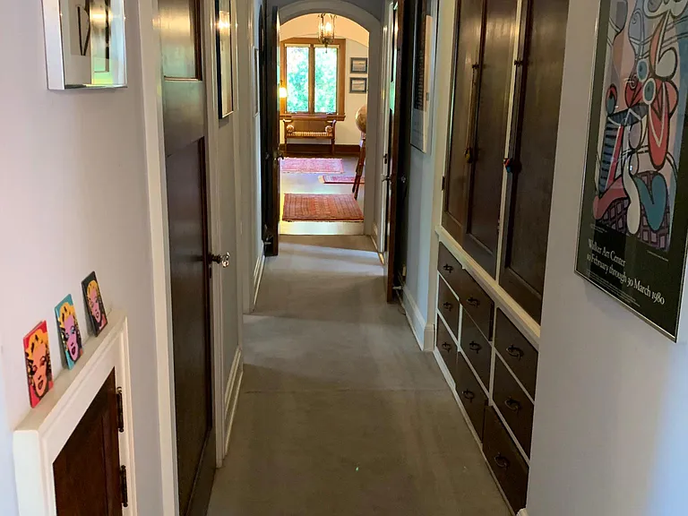 Hallway with linen closet and cedar closet from the bathroom toward entryway and living room