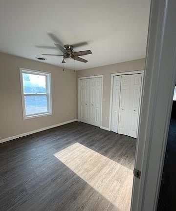 bedroom with double lighted closet area.
