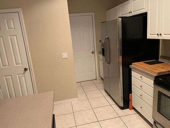@ Kitchen sink; straight ahead, door to garage; pantry across from fridge; door to left is under stairs closet