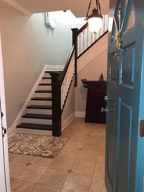 First floor entry way, stairs leading to the 2nd floor, living area
