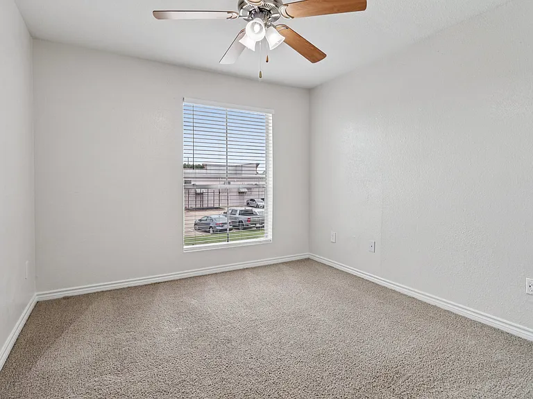 Bright and cozy carpeted room with a ceiling fan and sunny window view, perfect for relaxation. Bright and cozy carpeted room with a ceiling fan and sunny window view, perfect for relaxation.
