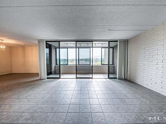 View from entrance door with dinning area to far left and enclosed terrace overlooking Truckee River directly in front.