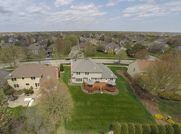Ariel view of backyard. The upgraded sprinkler system keeps you yard green year around. The cedar deck expands the back of the house with two seating areas.