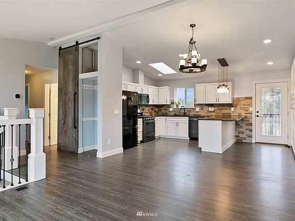 Up the stairs from the entry is the open concept kitchen, dining and living rooms.