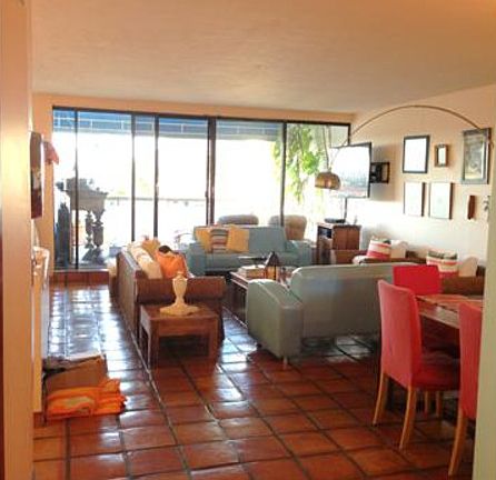 View from Kitchen towards dining/living area and beyond to patio