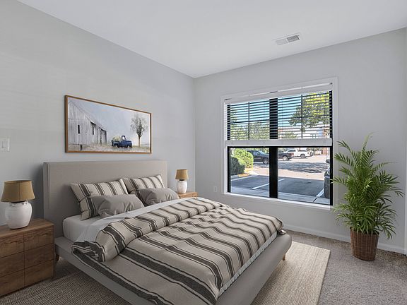 Spacious bedroom with plush carpeting