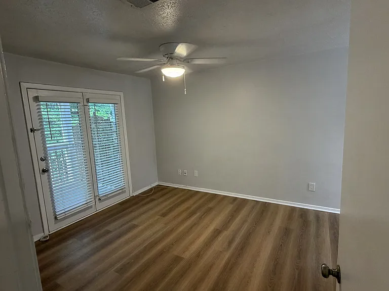 The master bedroom gets plenty of natural light and has direct access to the balcony.