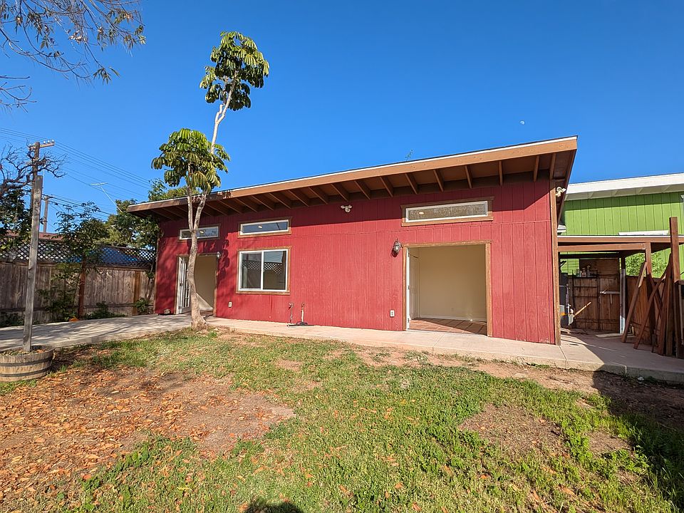 Large double doors and windows open into the large yard