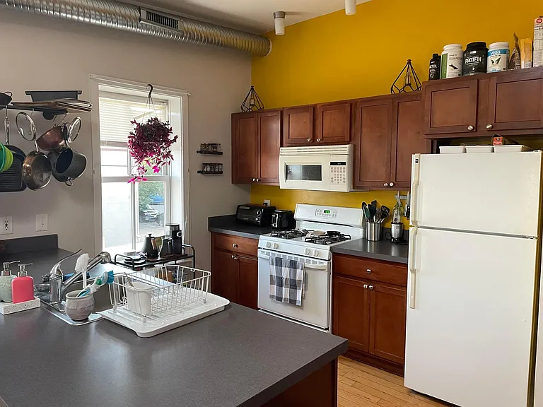 Kitchen with all appliances, corner dishwasher next to the sink.