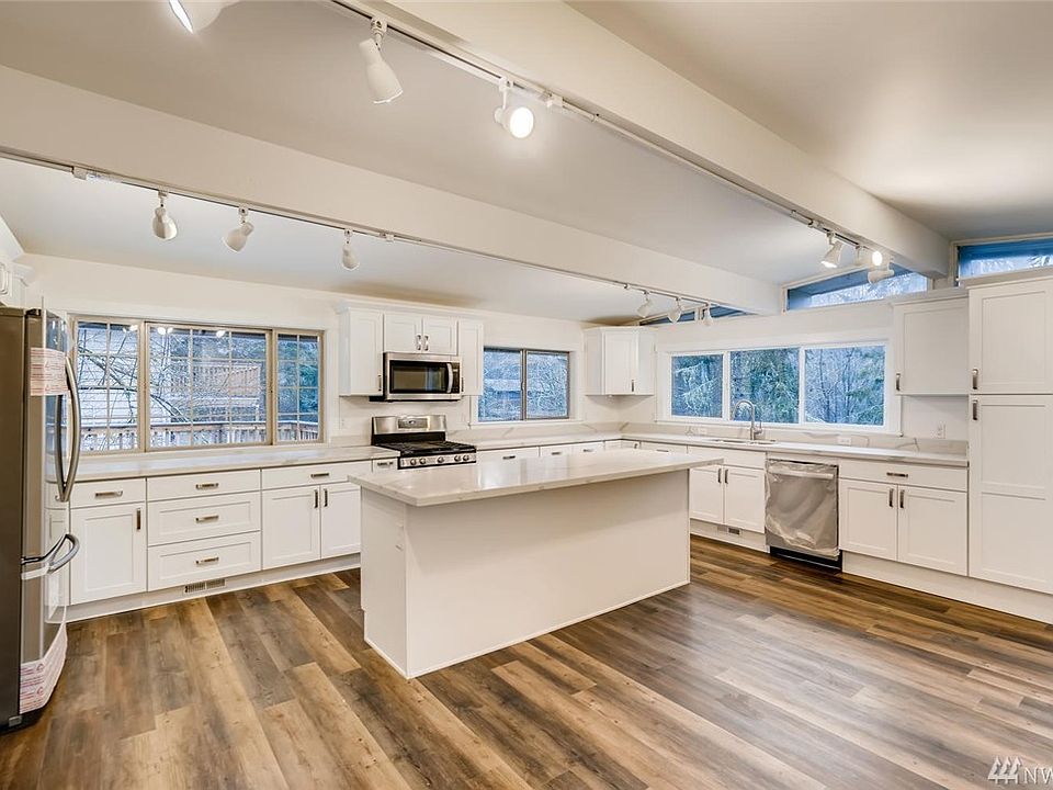 Stunning kitchen with vaulted ceilings, quartz counters, stainless appliances and all new cabinetry