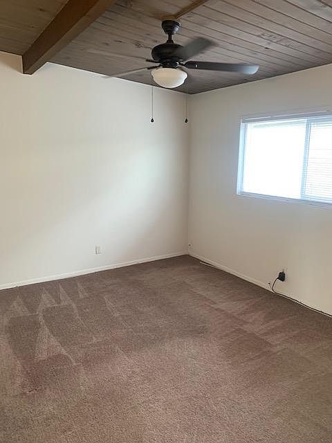 View of bedroom with ceiling fan.