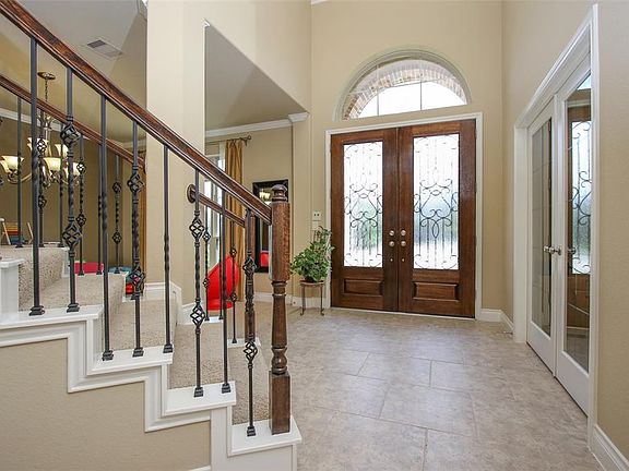 Elegant Entryway with Iron Spindles on the Stair Case, French Doors Into the Private Study and Open to Formal Dining Room!