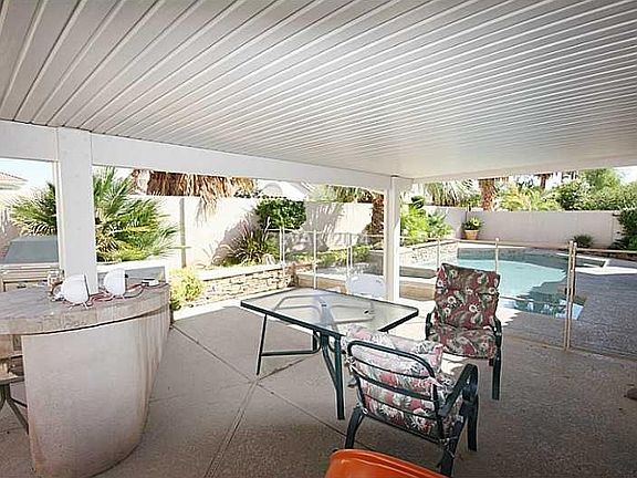 COVERED PATIO AND FENCE AROUND POOL