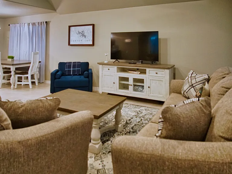 Comfortable open-concept living room flowing seamlessly into the dining area and kitchen.
