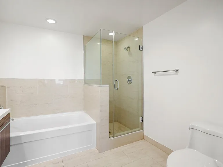 Bathroom with Bathtub and Walk-In Shower with Glass Door