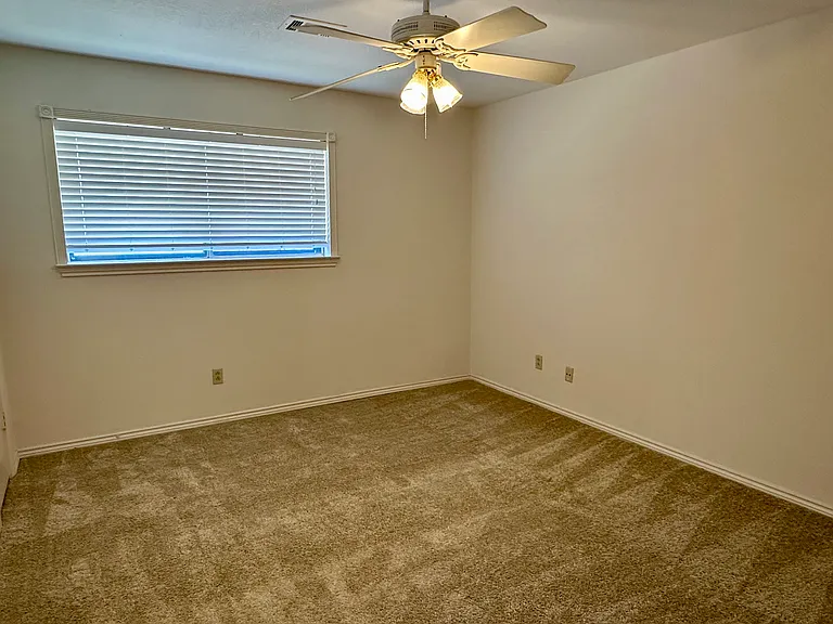 Bedroom featuring a ceiling fan, carpet flooring