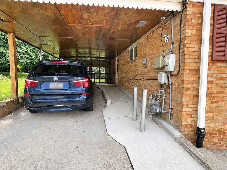 Step-free walkway from carport into kitchen with wide entry door.