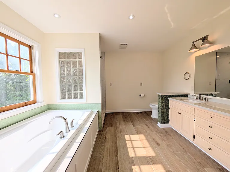The master bath is newly renovated with a soaker tub, granite his and her vanity and a spacious luxury shower. Floor and shower are porcelain tile so very easy to clean!