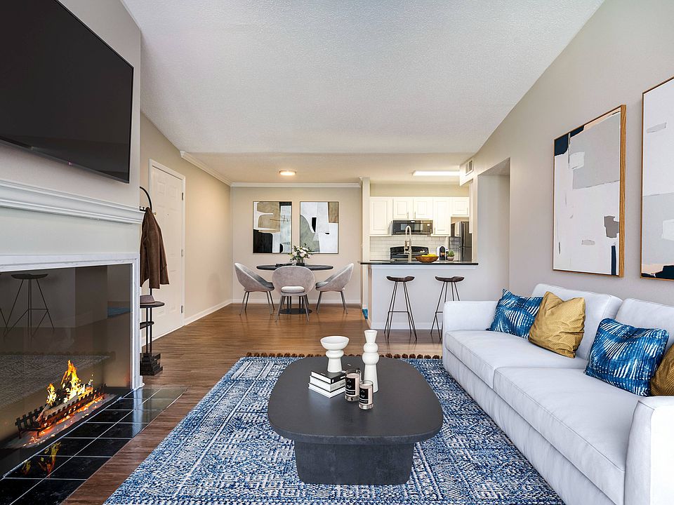Open concept living area looking into dining and kitchen areas