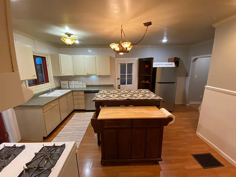 The kitchen pocket lighting, lights, and chandelier dim to create a dining ambiance!