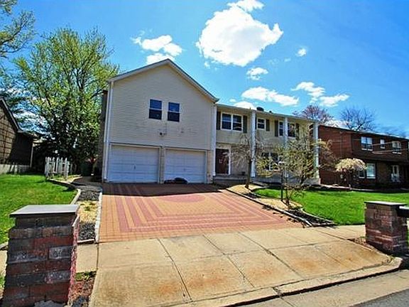 Front View : 2 Car Garage, 2 car pavers drive way with 4 car street parking